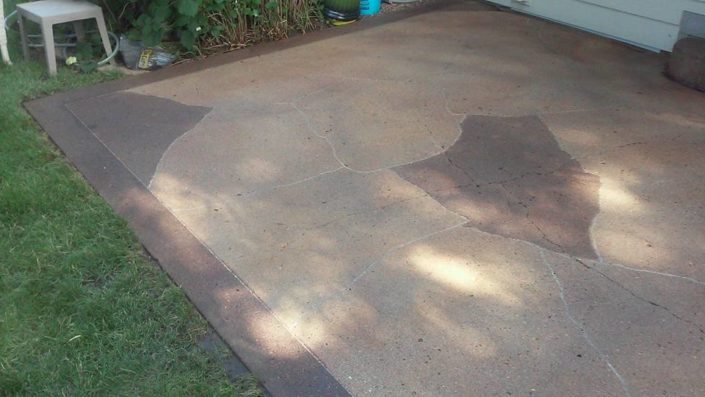 Acid stained patio with solid border and flagstone engraving