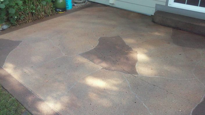 Acid stained patio with solid border and flagstone engraving